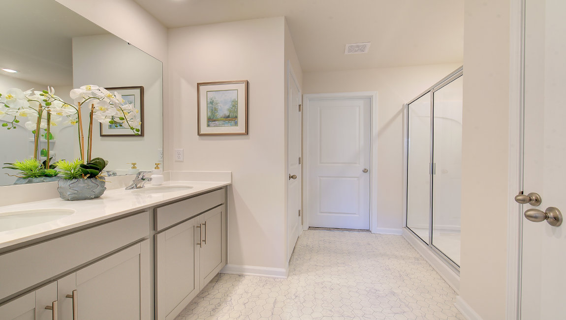 Primary bathroom with dual vanity and walk in showert
