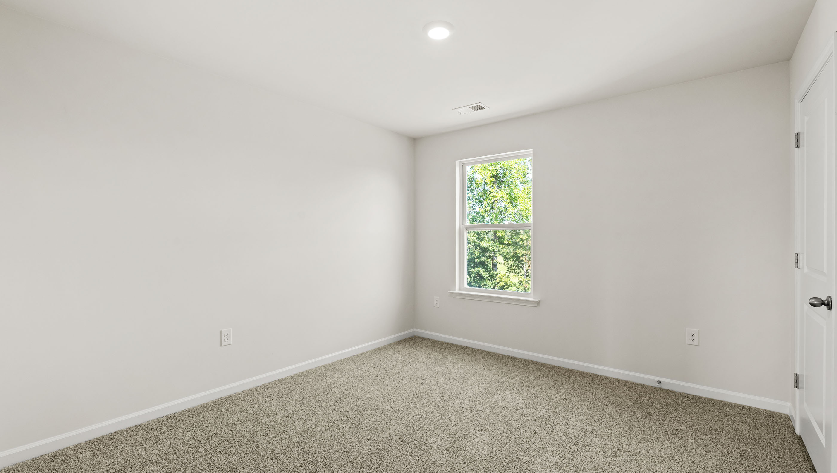 Carpeted bedroom with window