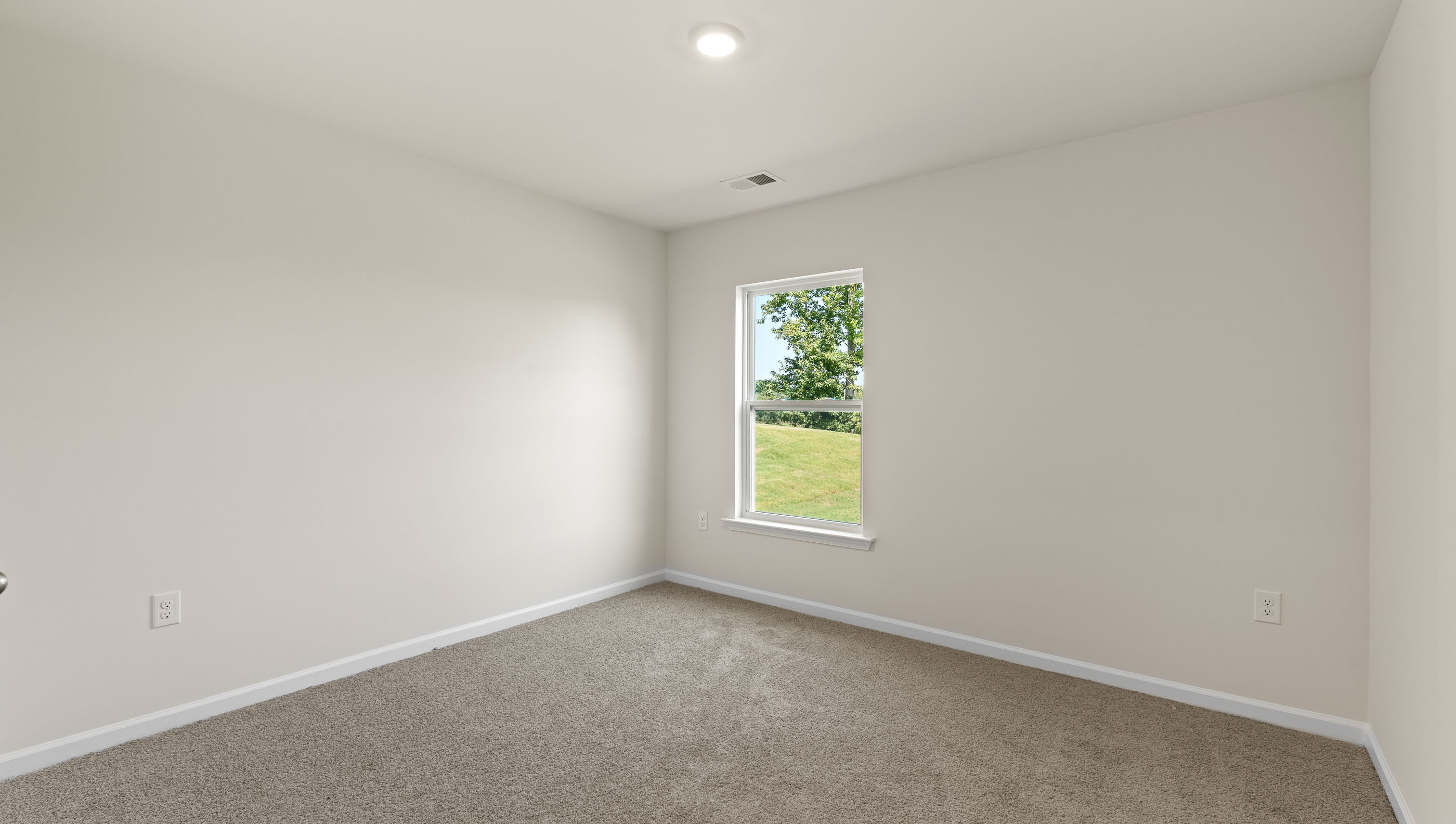 Carpeted bedroom with window