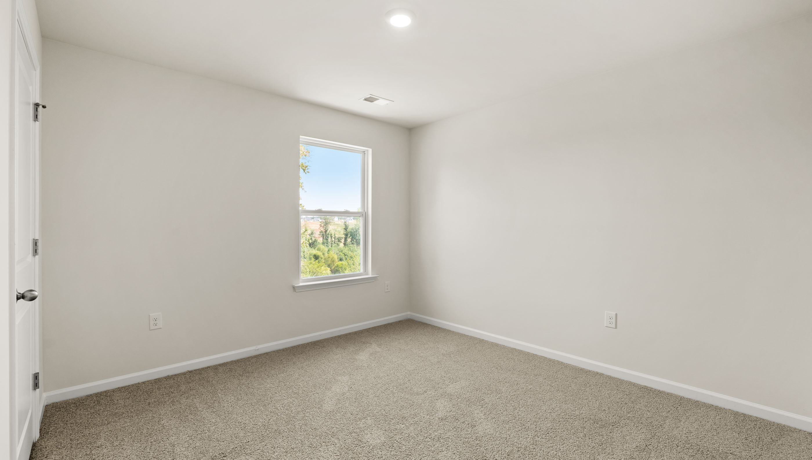 Carpeted bedroom with window