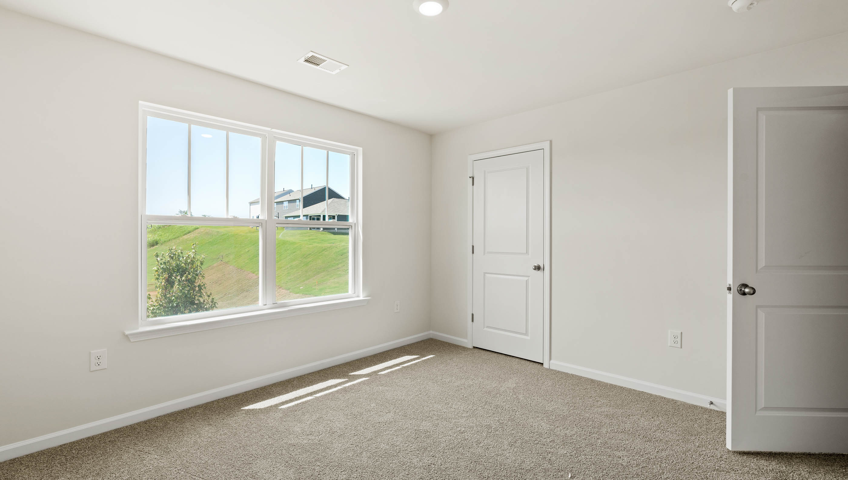 Carpeted bedroom with window