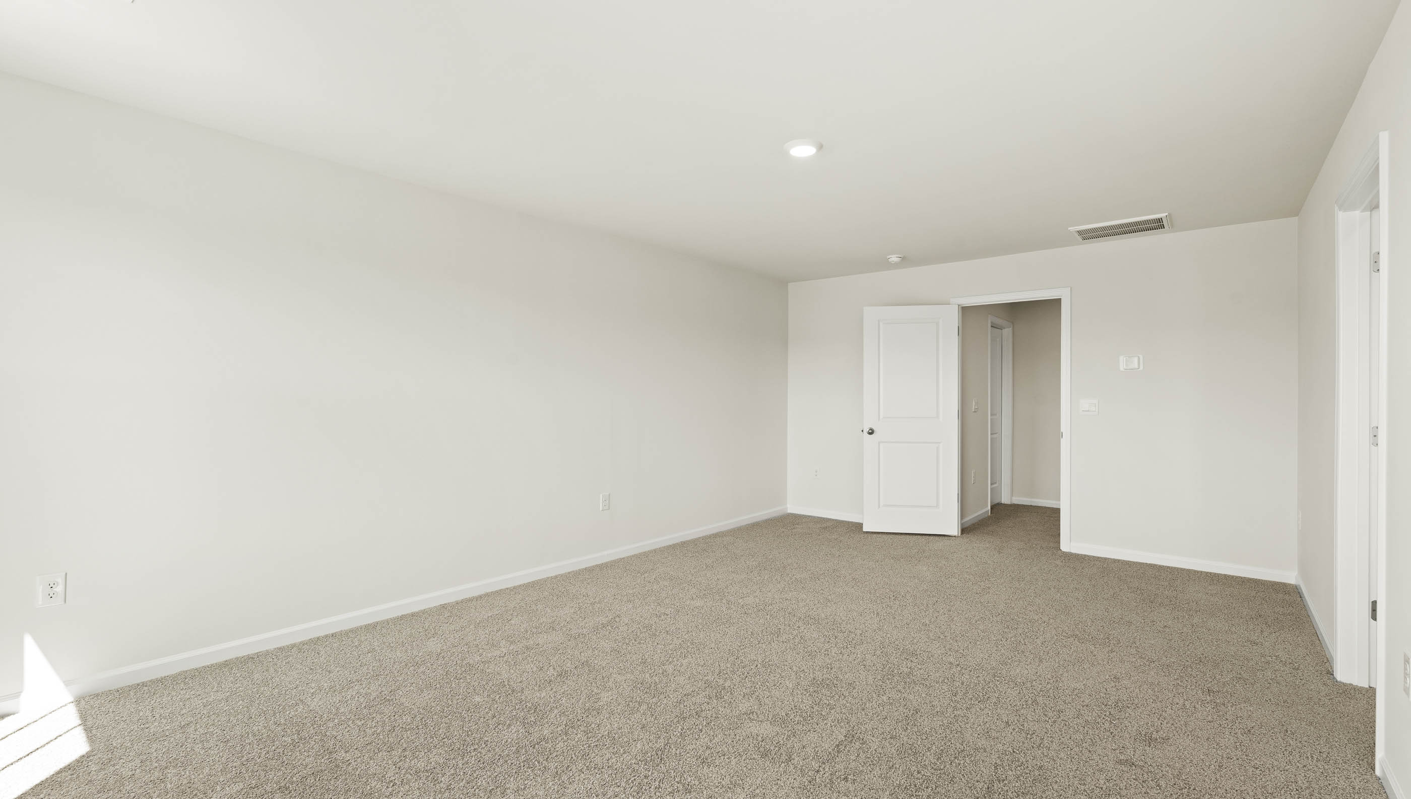 Carpeted bedroom with window