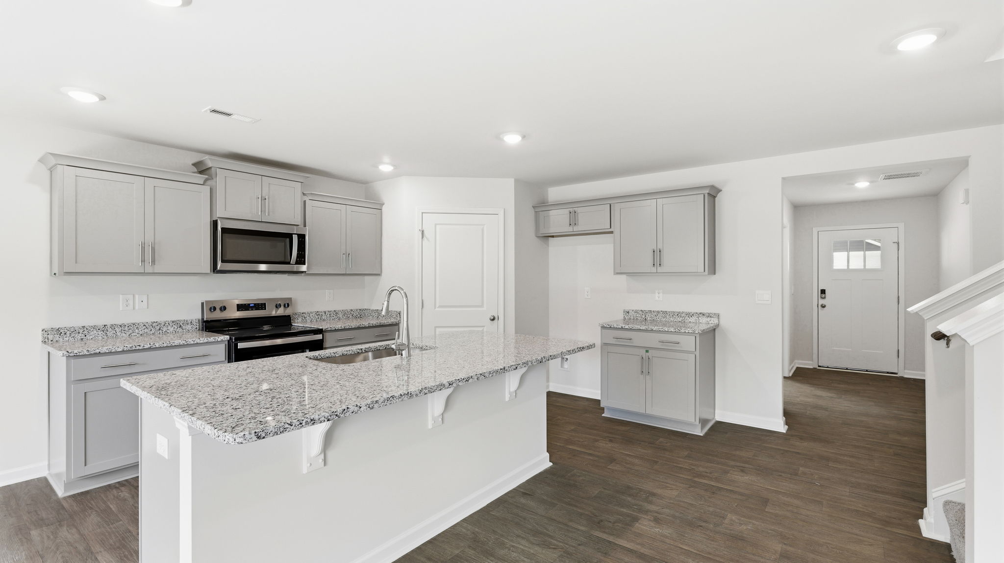 Open concept kitchen with large island and stainless steel appliances