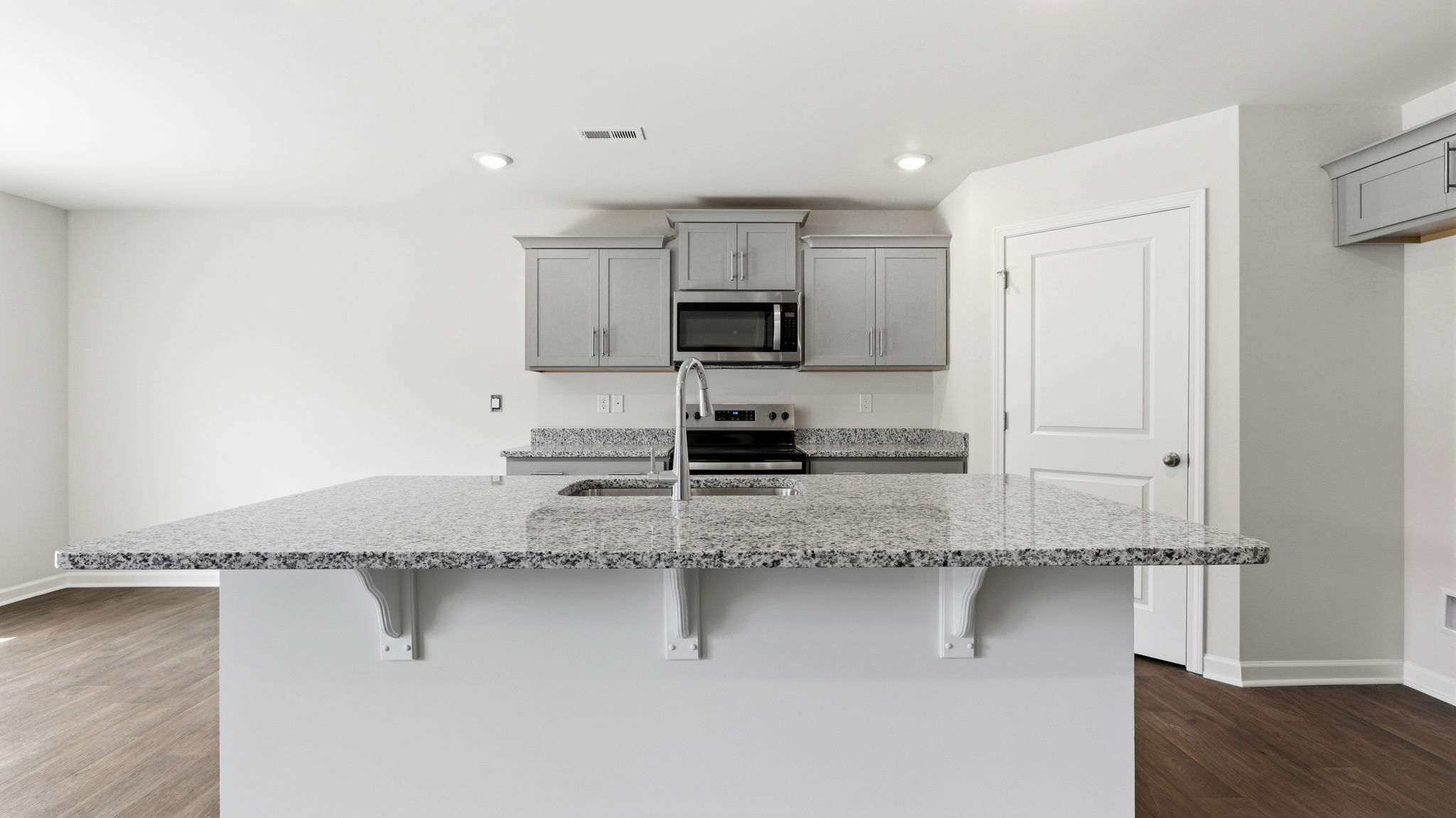 Open concept kitchen with large island and stainless steel appliances