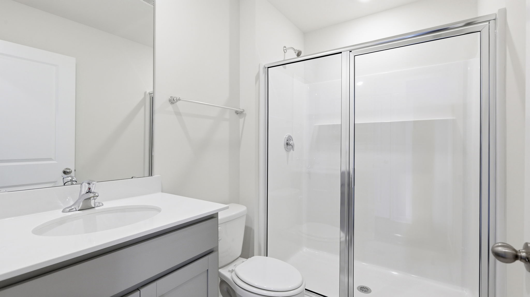 Primary bathroom with dual vanity and walk in shower