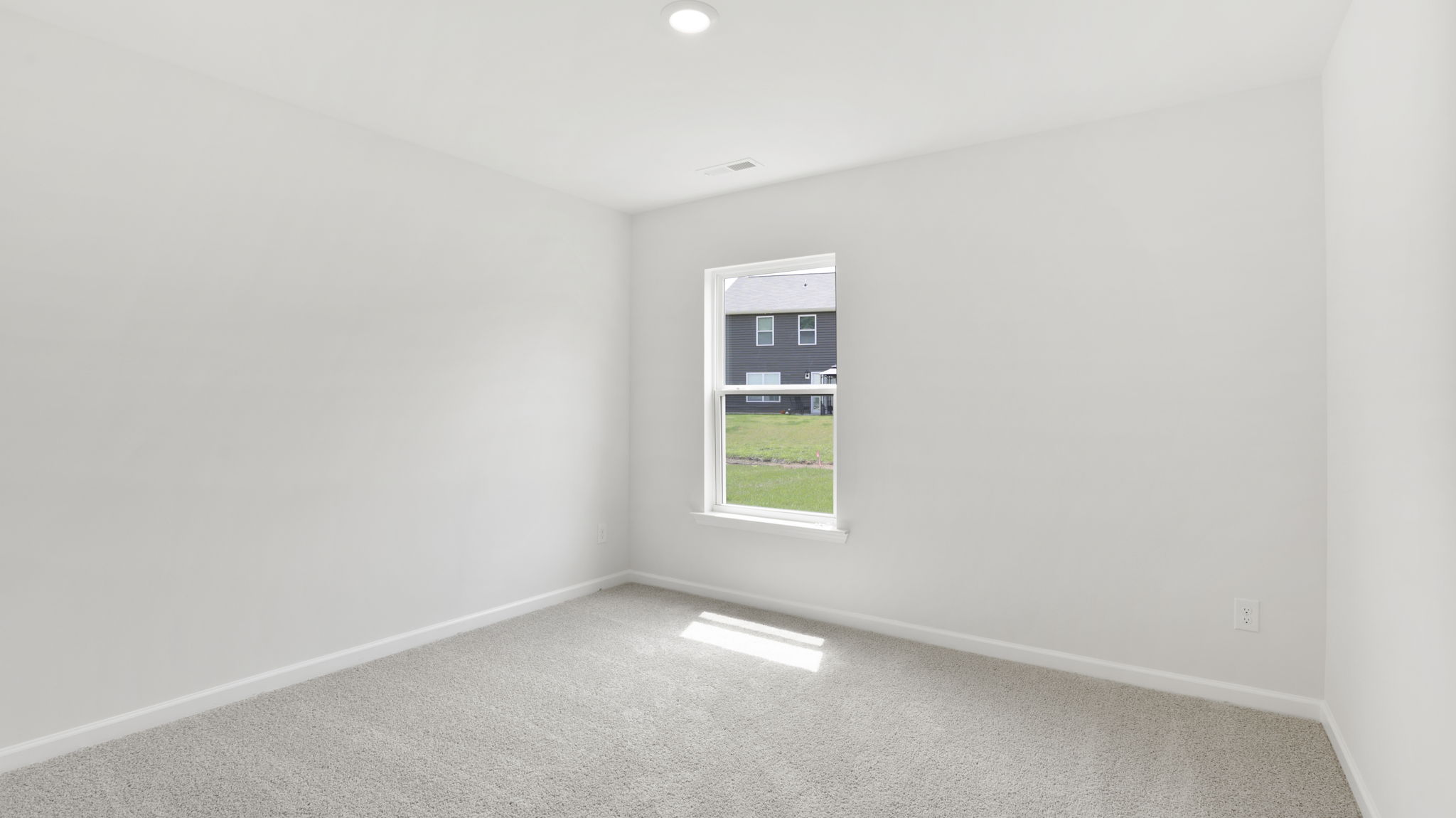 Carpeted bedroom with window