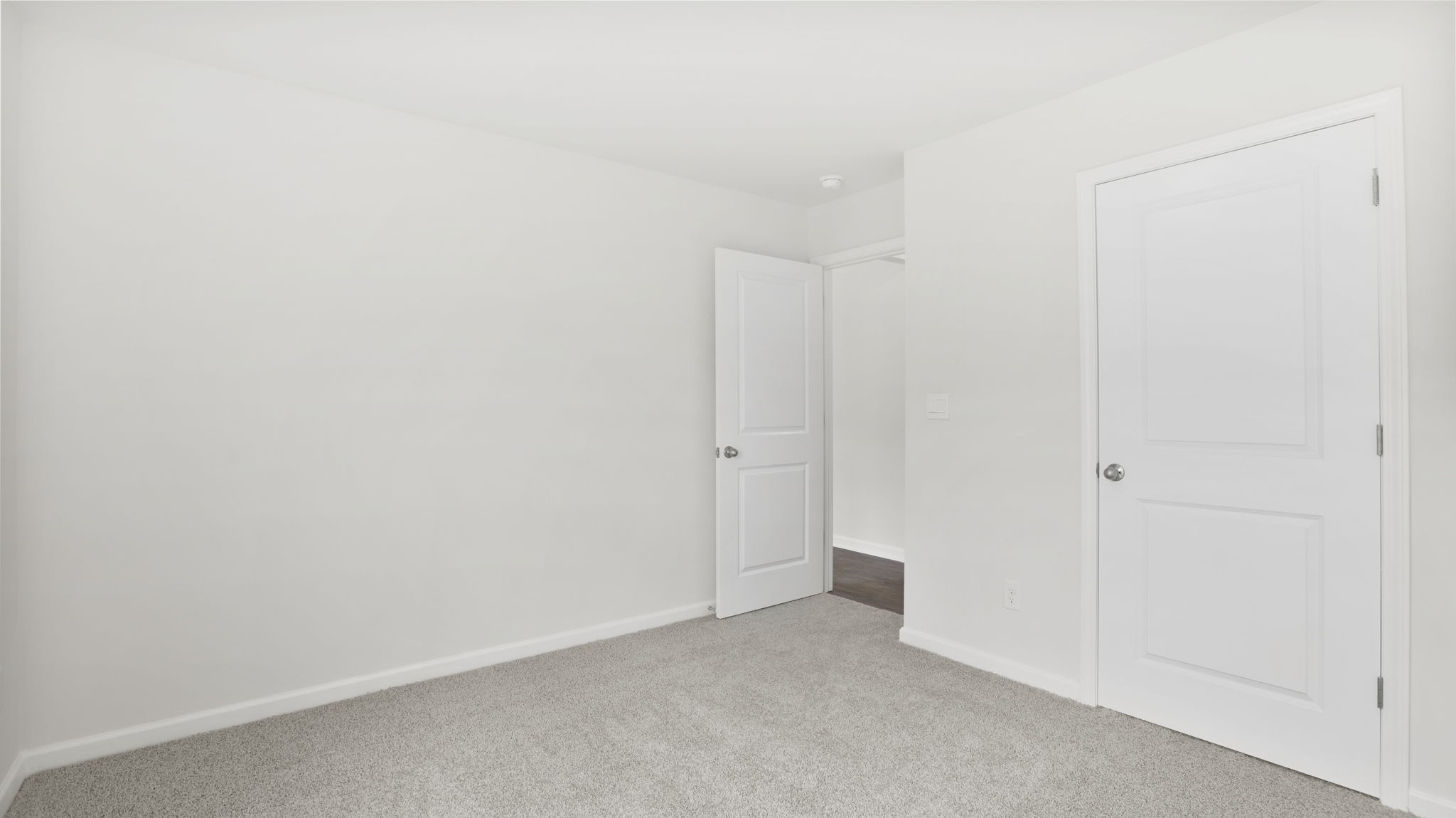 Carpeted bedroom with closet