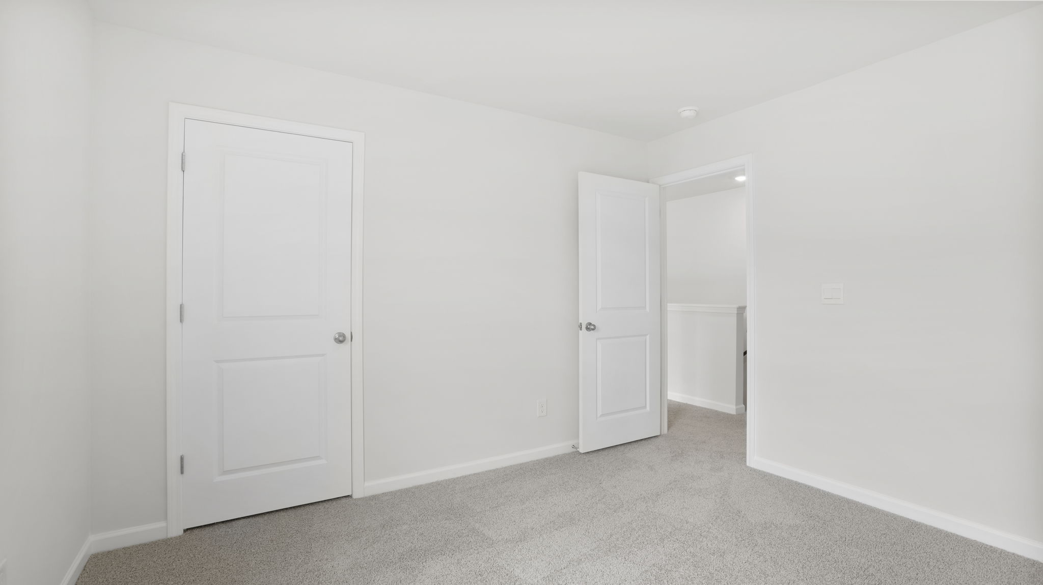 Carpeted bedroom with closet