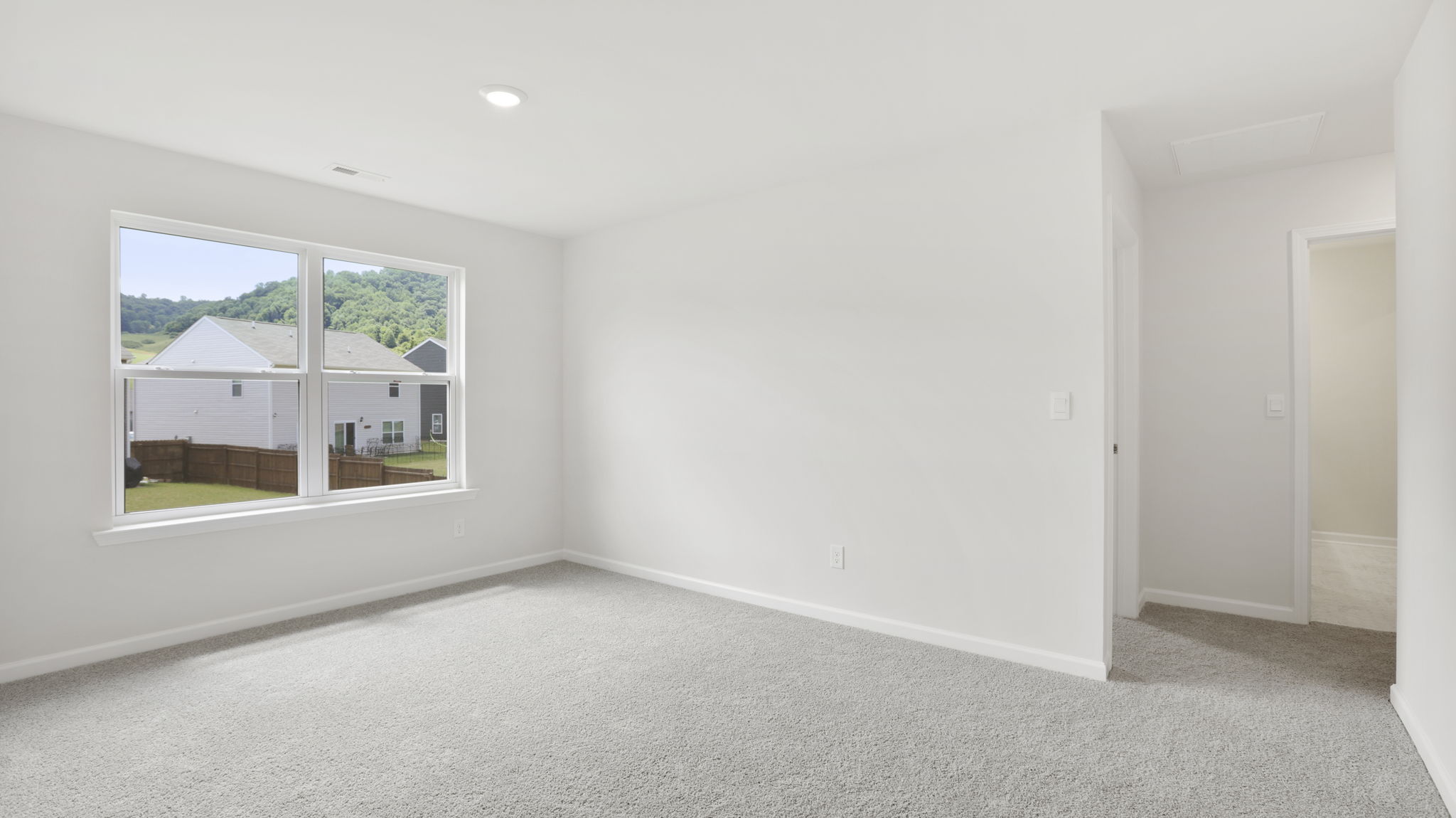 Carpeted bedroom with window