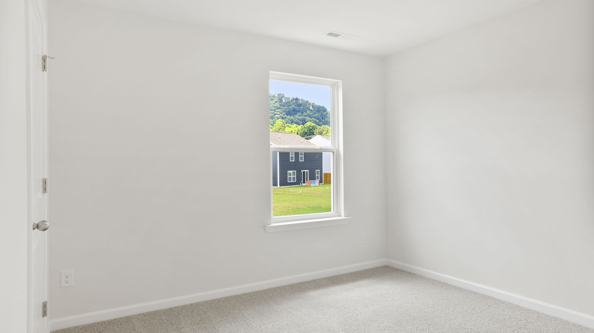 Carpeted bedroom with window