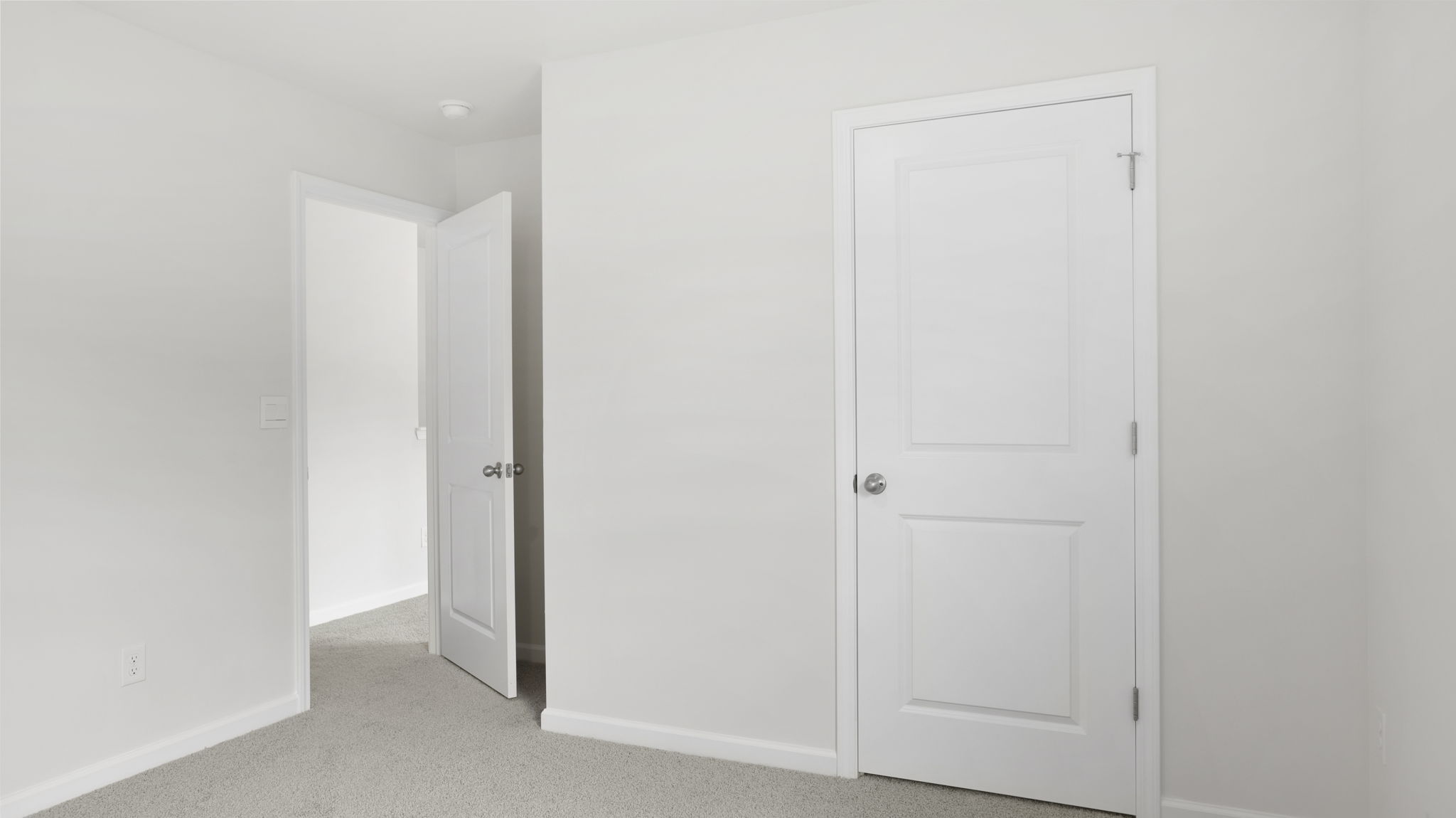 Carpeted bedroom with closet