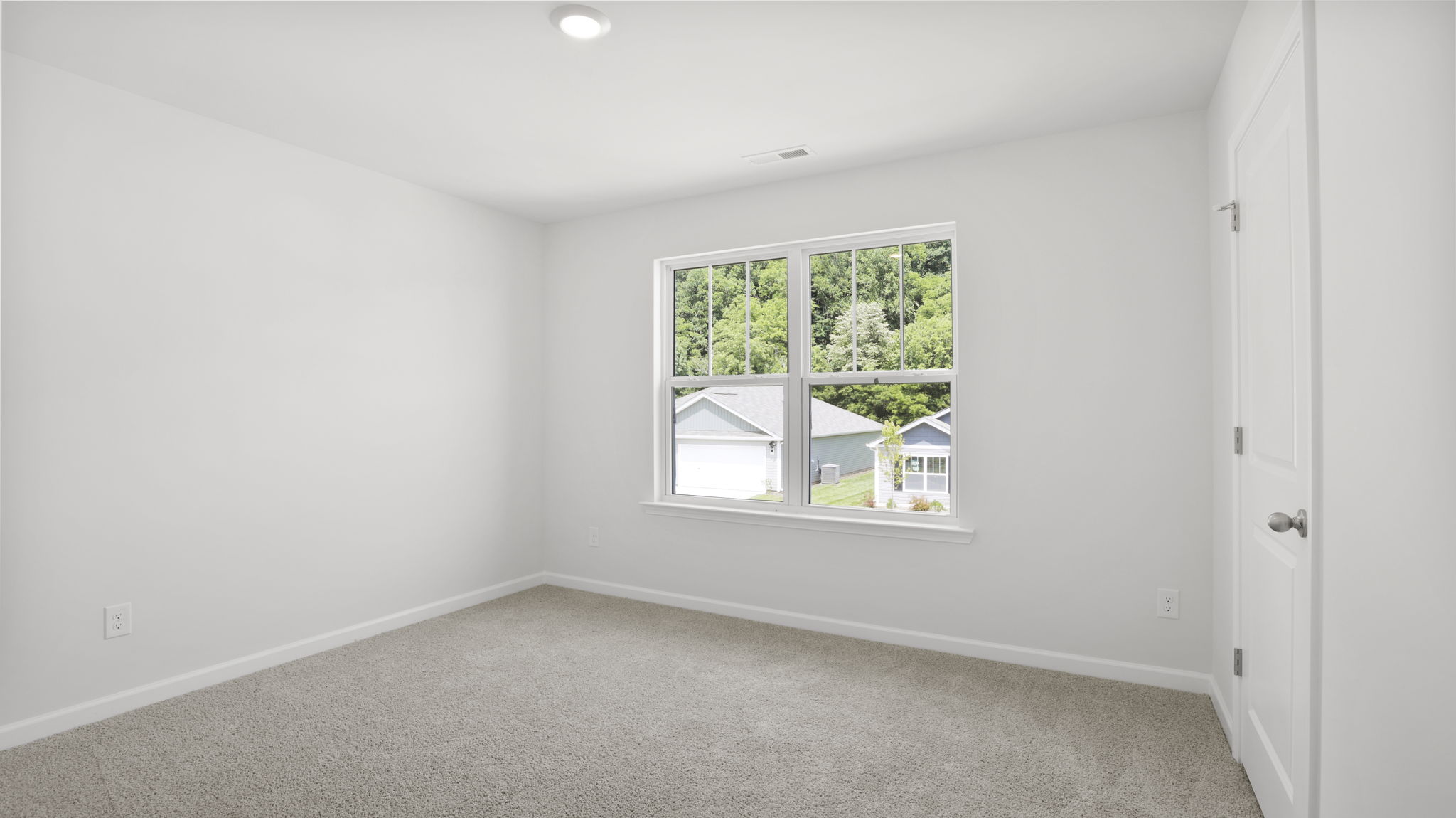 Carpeted bedroom with large windows
