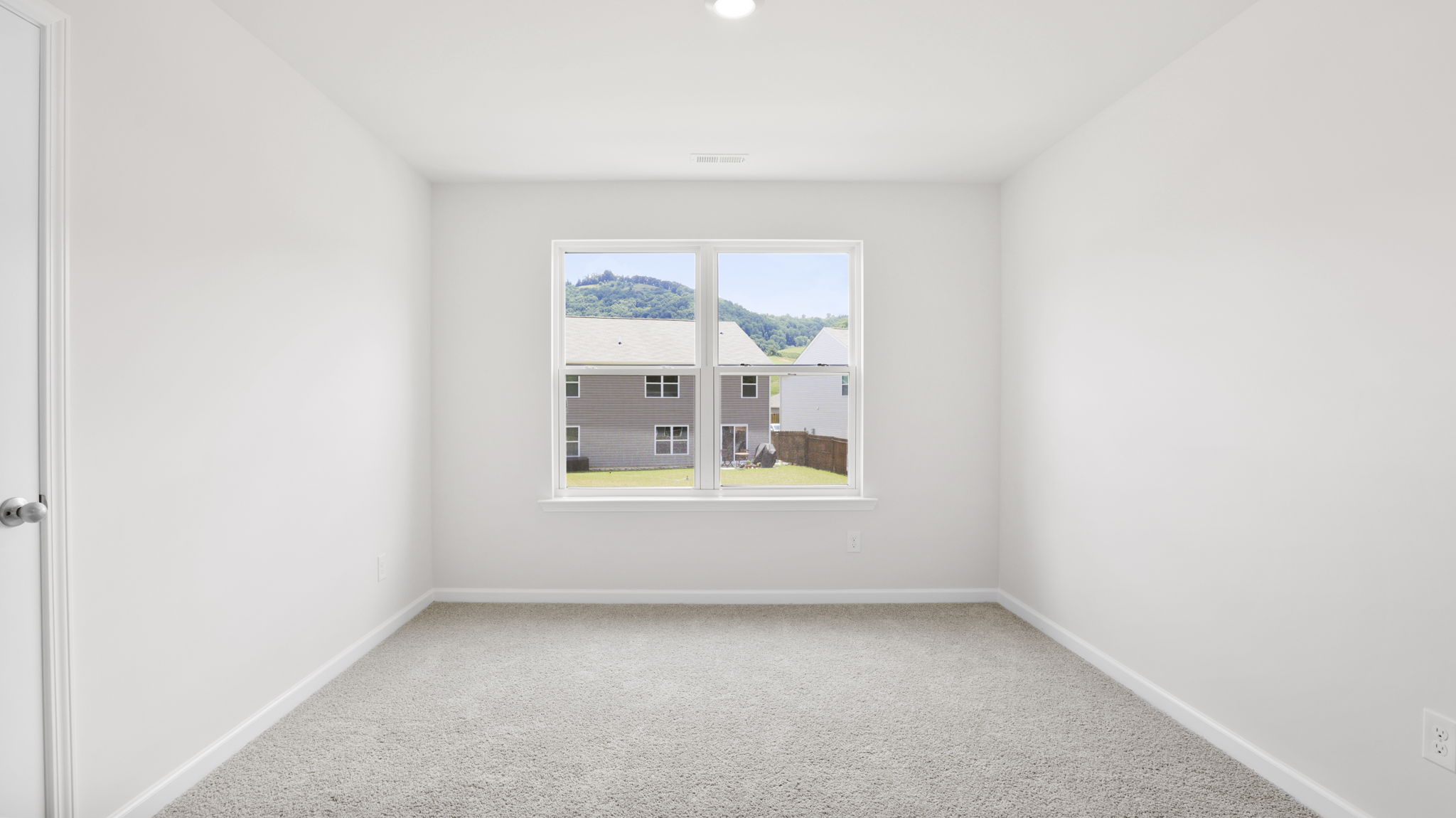 Carpeted bedroom with large windows