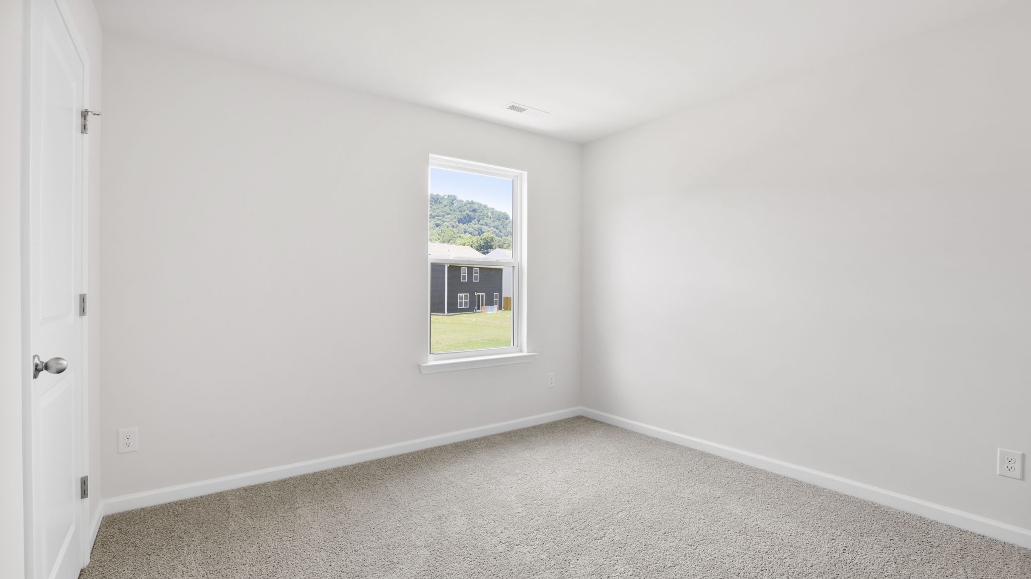 Carpeted bedroom with large windows