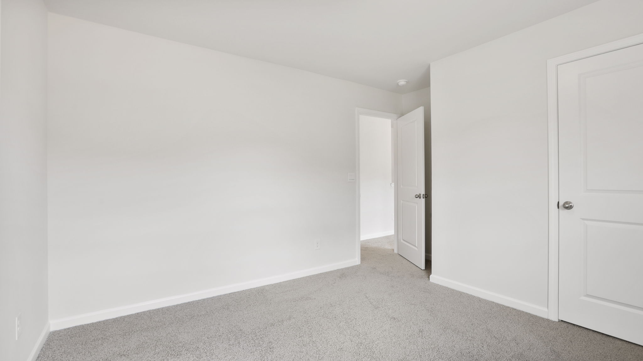 Carpeted bedroom with closet