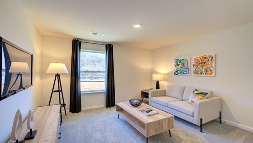 carpeted loft space with window