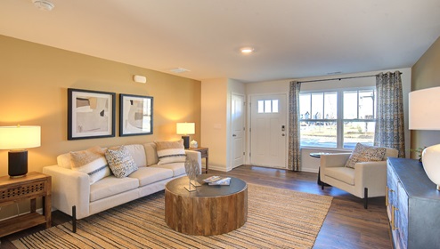 family room with view of front door and large window