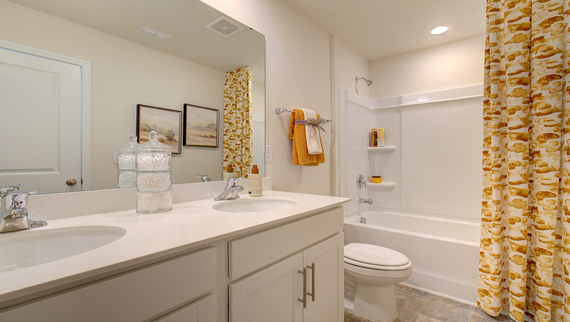 Bathroom with white counters and cabinets