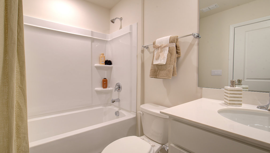 Bathroom with white counters and cabinets