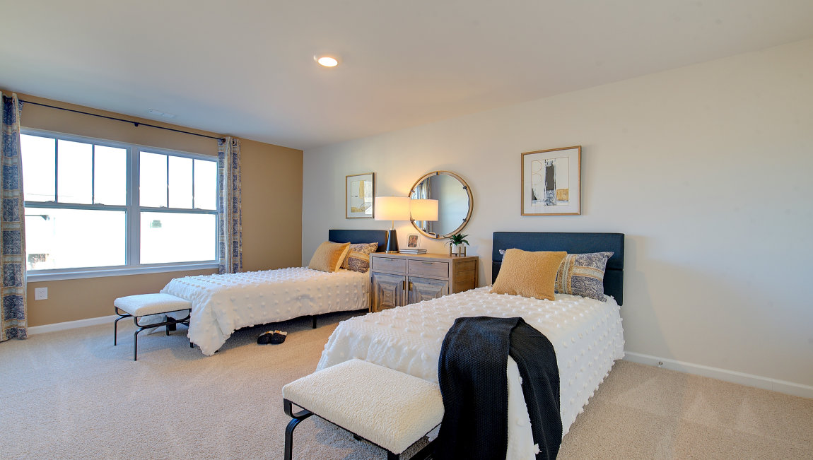 Carpeted bedroom with two large windows