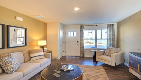 family room with view of front door and large window