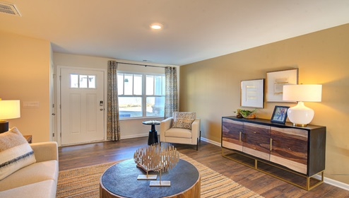 family room with view of front door and large window