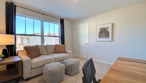 Carpeted bedroom with large window
