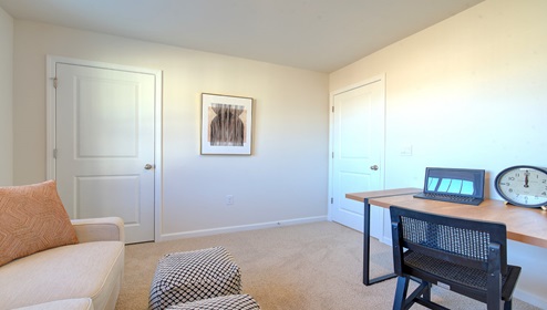 Carpeted bedroom with large window