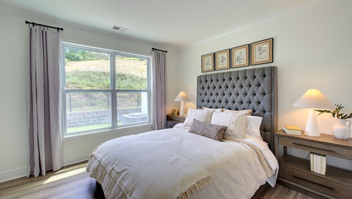 Carpeted bedroom with large window
