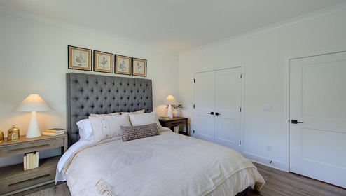 Carpeted bedroom with large window