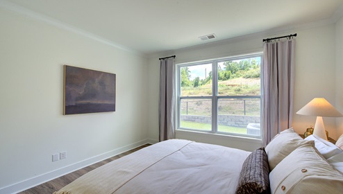 Carpeted bedroom with large window