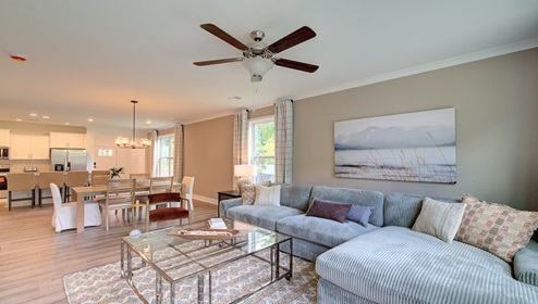 Living room with large window and back door, with wood floors