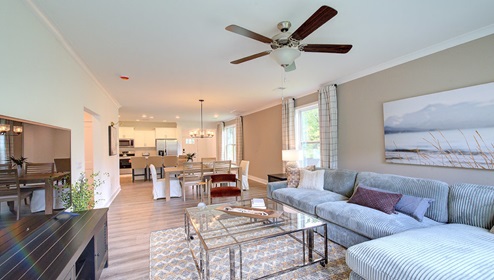 Living room with large window and back door, with wood floors
