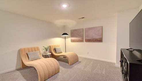 Upstairs loft space, carpeted, with staircase railing