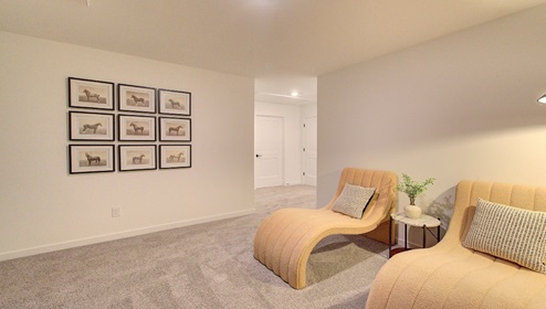 Upstairs loft space, carpeted, with staircase railing
