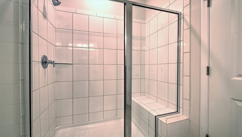 Bathroom with glass door shower with built in bench