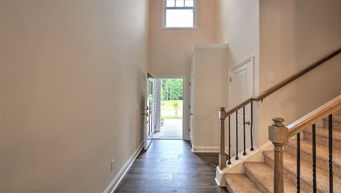 Welcoming foyer with view of front door and staircase