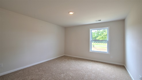 carpeted bedroom with large window