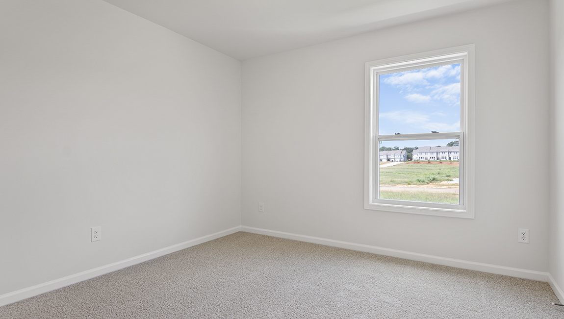 Carpeted bedroom with large window
