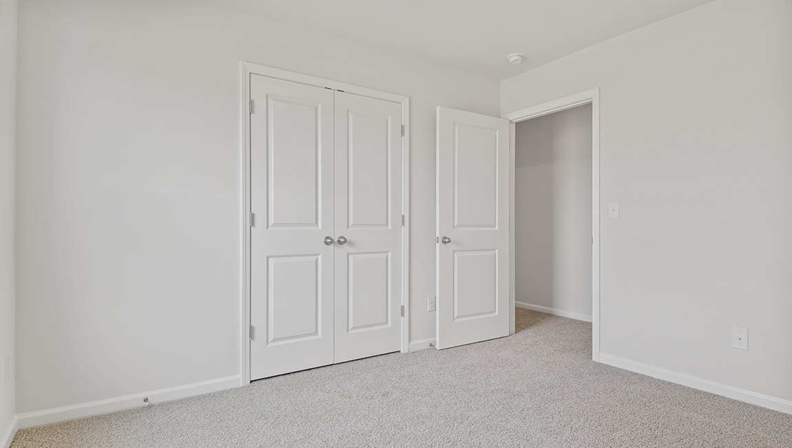 Carpeted bedroom with large window