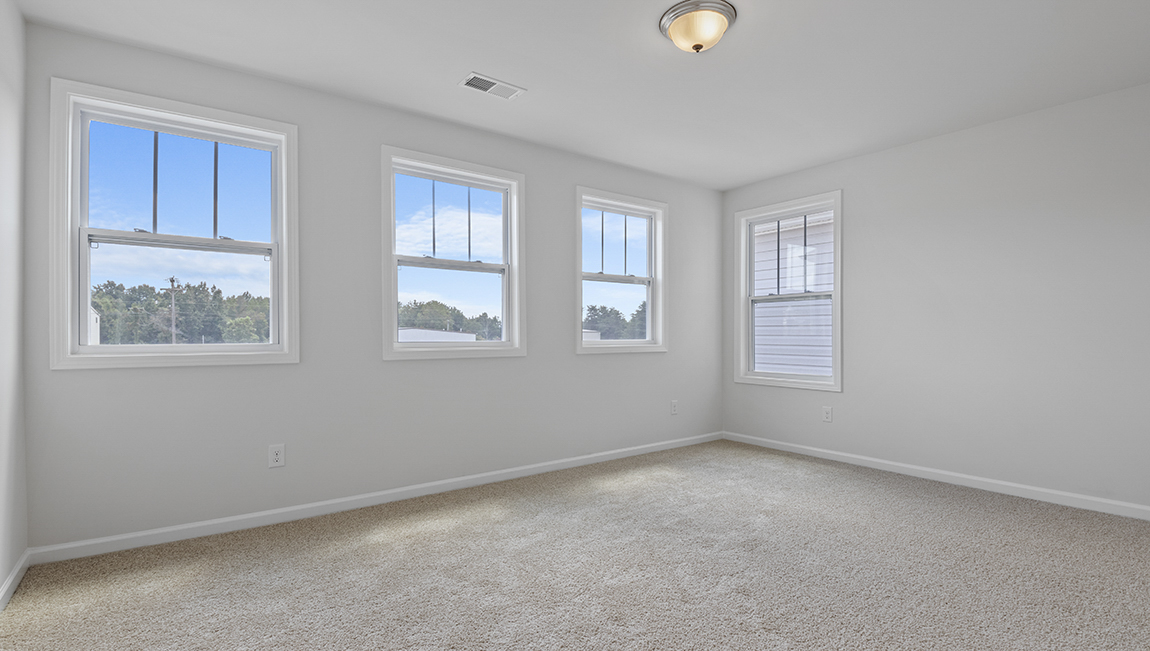 Carpeted bedroom with large window