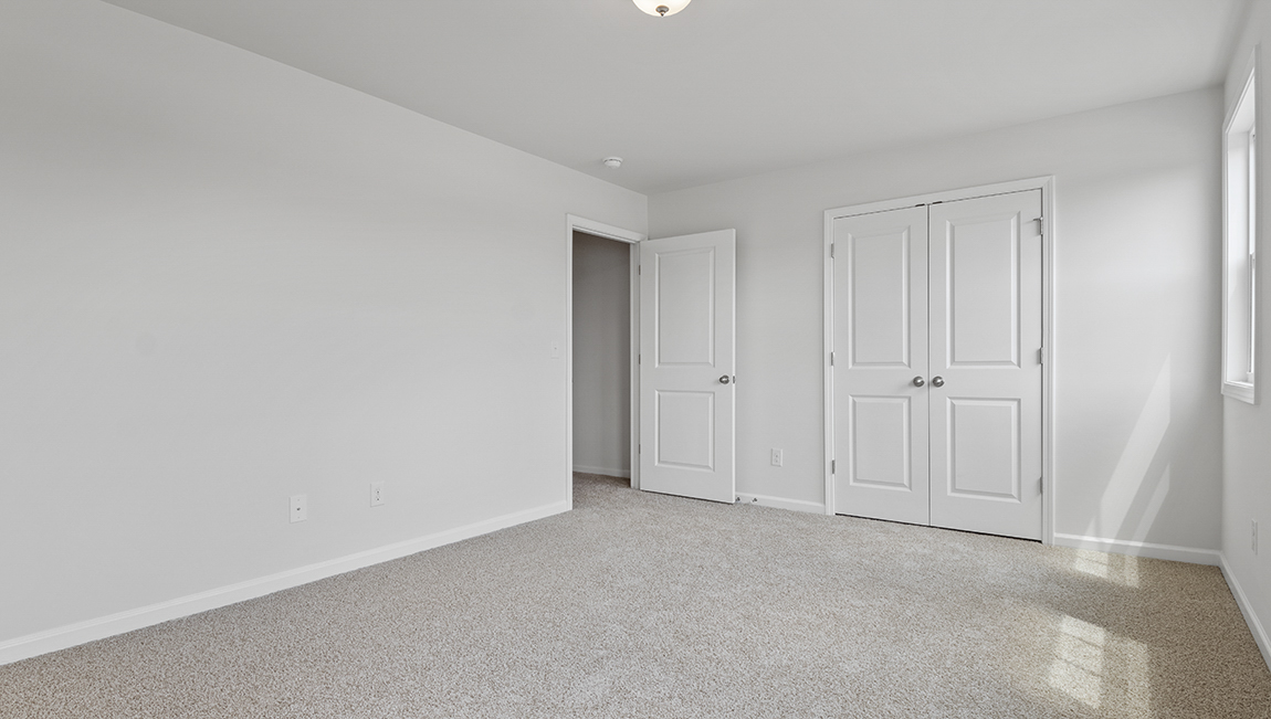 Carpeted bedroom with large window