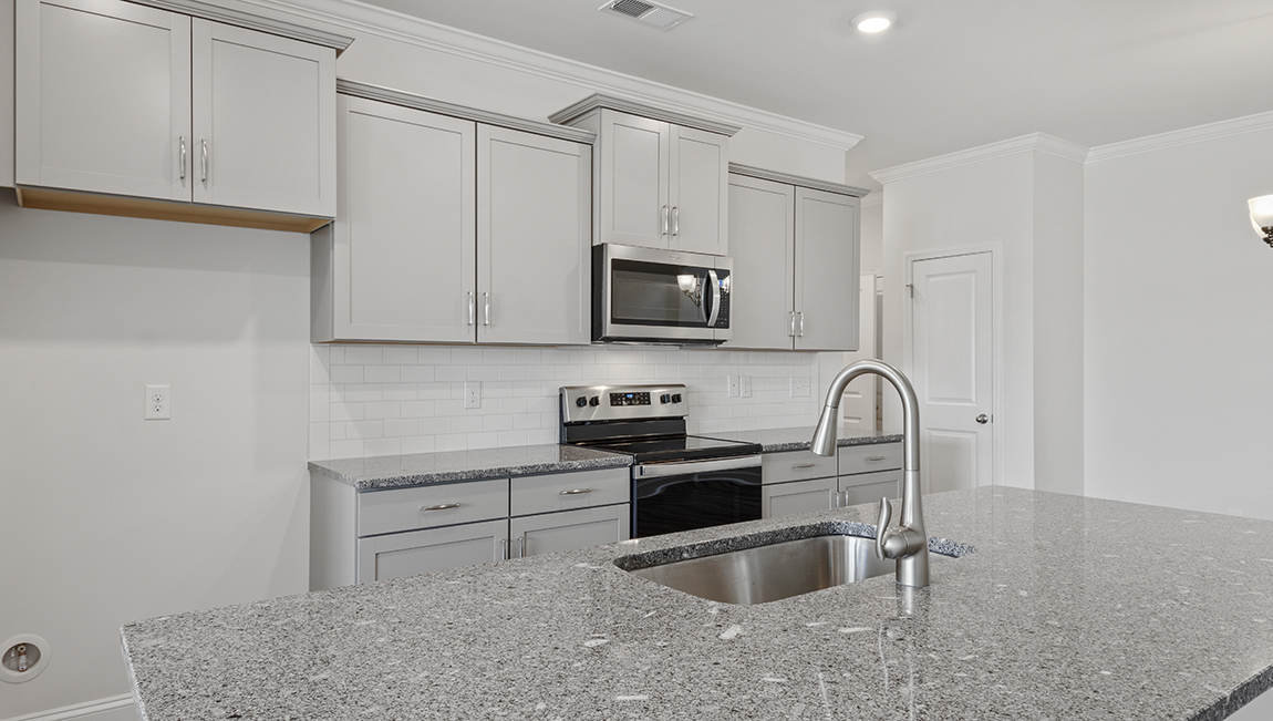 Kitchen and island with stainless steel appliances