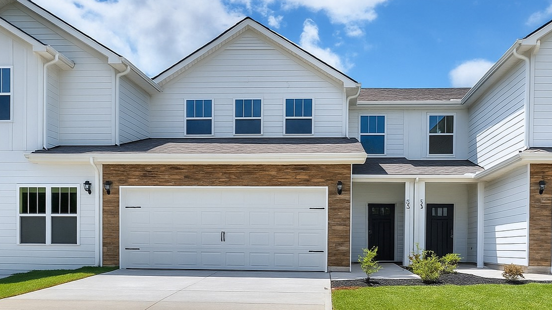 front exterior of a townhome with a one car garage