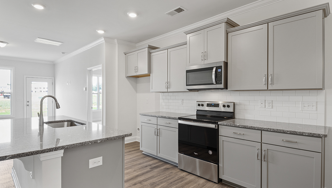 Kitchen and island with stainless steel appliances