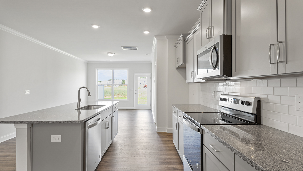 Kitchen and island with stainless steel appliances