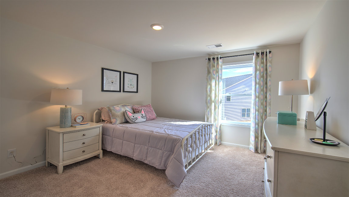 Carpeted bedroom with large windows