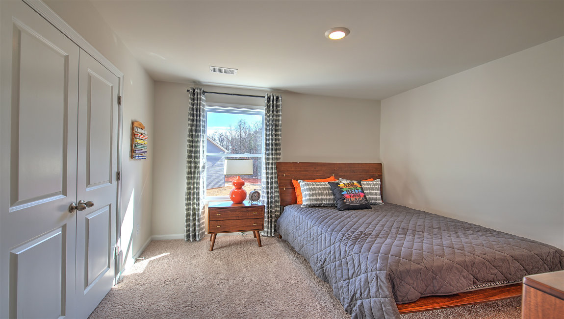 Carpeted bedroom with large window