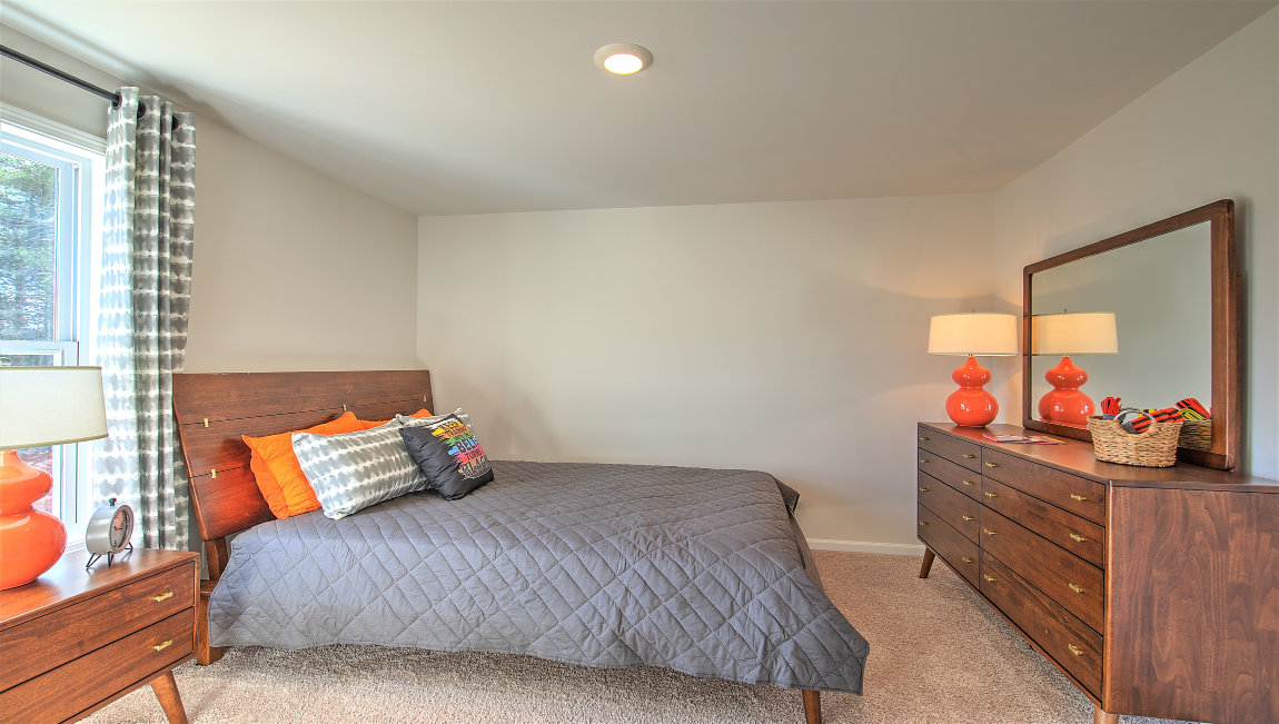Carpeted bedroom with large window