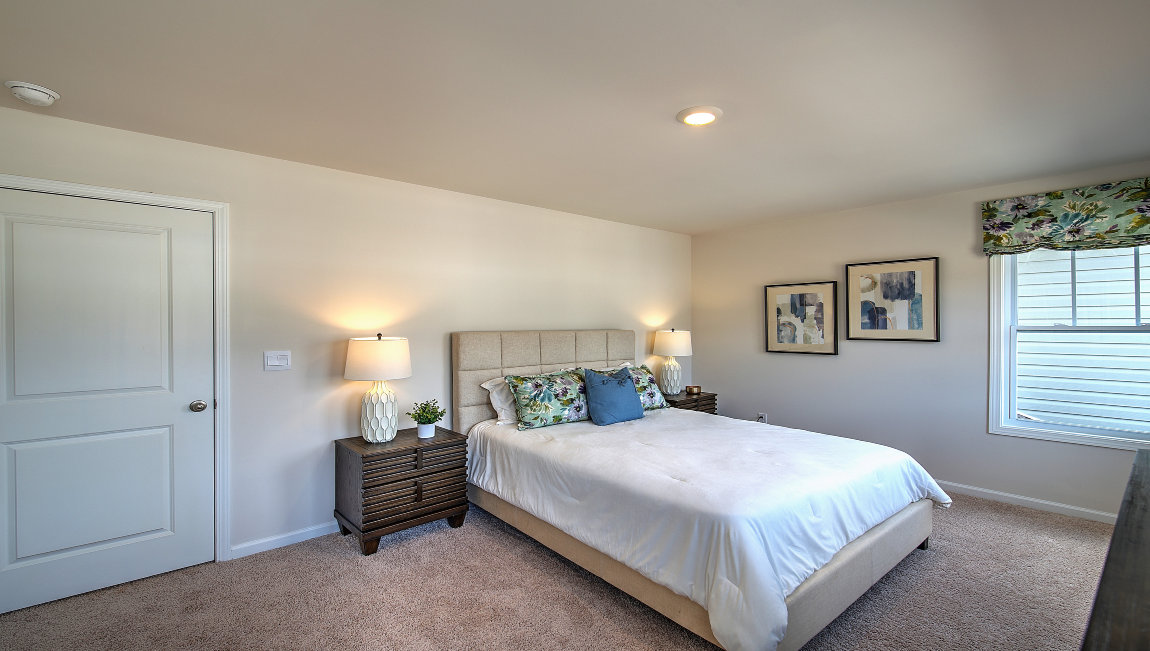 Carpeted bedroom with large window